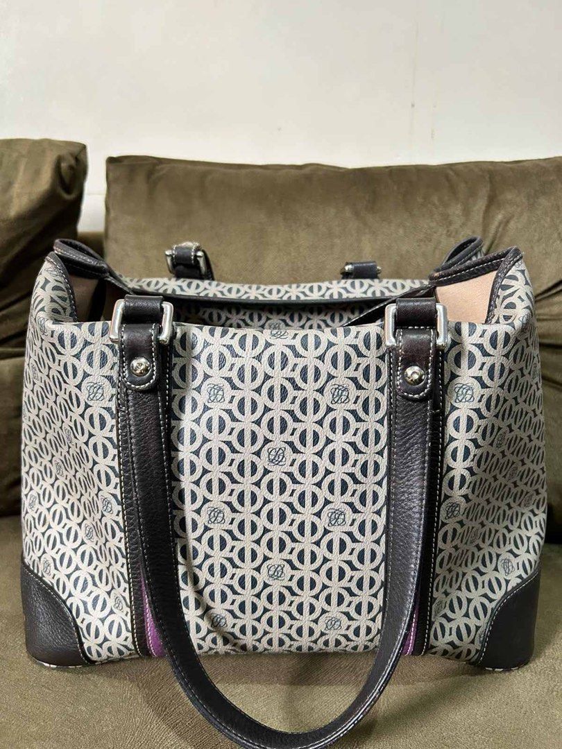 Patterned Tote Bag with Dark Leather Straps (Category: Tote Bags) located in Quezon City. Submitted by rosell.xoxo (Listing ID 1466611934, Image 1). Description: - Stylish geometric monogram fabric with dark brown leather trim and handles - Silver-toned hardware and eye-catching purple accent stripe on the side - Open top design with a secure center clasp strap closure - Structured base featuring protective leather panels - Roomy light-colored fa