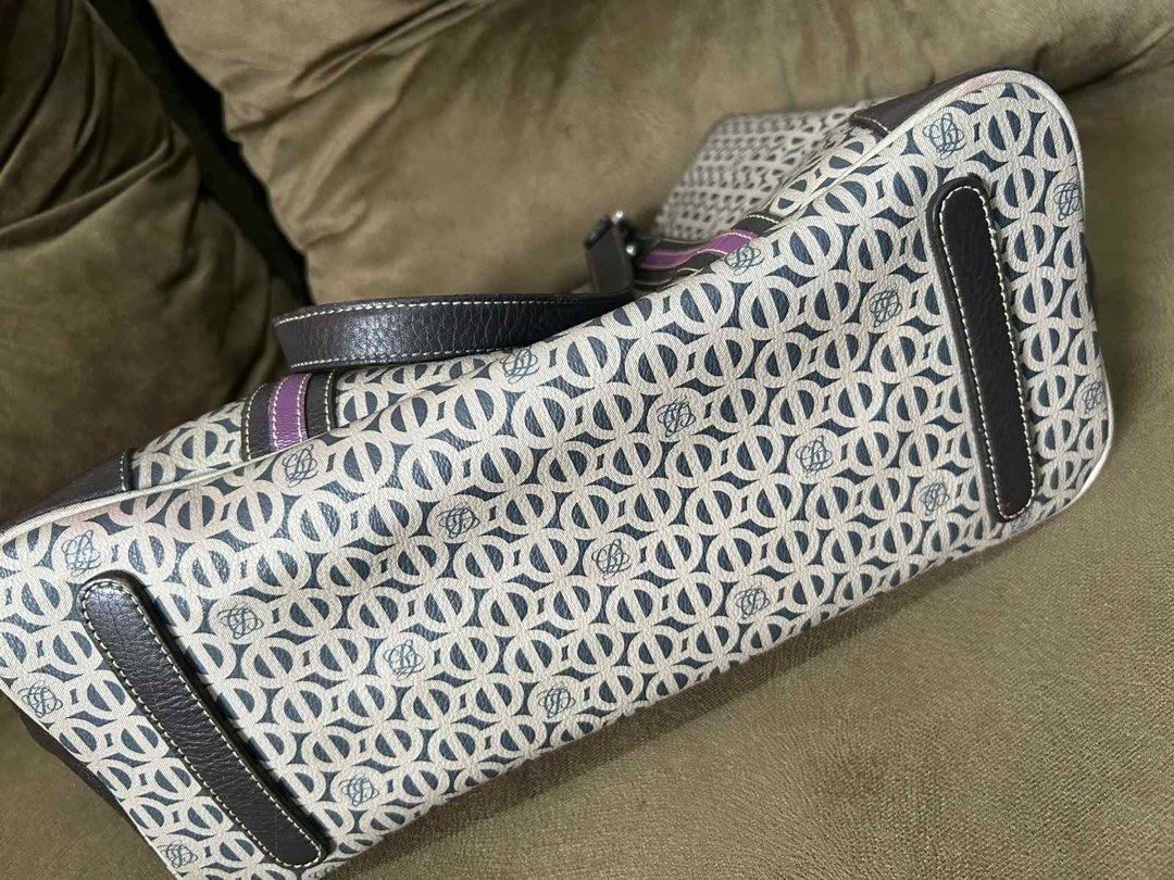Patterned Tote Bag with Dark Leather Straps (Category: Tote Bags) located in Quezon City. Submitted by rosell.xoxo (Listing ID 1466611934, Image 2). Description: - Stylish geometric monogram fabric with dark brown leather trim and handles - Silver-toned hardware and eye-catching purple accent stripe on the side - Open top design with a secure center clasp strap closure - Structured base featuring protective leather panels - Roomy light-colored fa