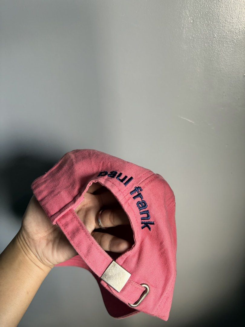 Paul Frank Pink Baseball Cap with Logo Patch (Category: Caps & Hats) located in Manila. Submitted by silentwhale_543e69 (Listing ID 1466682167, Image 2). Description: - Authentic Paul Frank pink baseball cap - Classic six-panel design in clean cotton twill - Features embroidered brand patch on the front, '62' on the side, and text near the back - Adjustable metal buckle closure for a custom fit - Inner brown brand label (Size F) - Condition: Exce