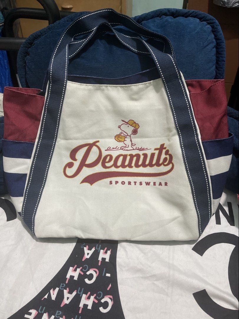 Peanuts Snoopy Canvas Tote Bag Blue Red (Category: Tote Bags) located in Manila. Submitted by edensy (Listing ID 1466675132, Image 2). Description: - Authentic Peanuts Snoopy design with vibrant red, white, and blue contrast panels - Features fun athletic department graphic prints on both sides - Durable canvas fabric construction built for daily use - Comfortable double shoulder straps with secure stitched details - Spacious size perfect for car