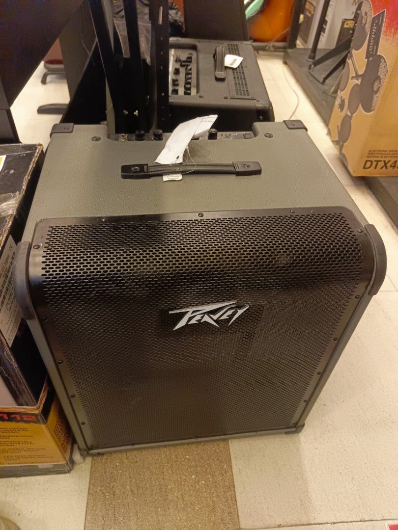 Peavey MAX 300 Bass Amplifier (Category: Musical Instruments) located in Manila. Submitted by shelian09 (Listing ID 1466637707, Image 1). Description: - Model: Peavey MAX 300 Bass Amp - Condition: Clean and well-maintained unit - Build: Solid construction with heavy-duty front metal grille - Controls: Top-mounted gain, bass, mid, treble, volume knobs, and built-in chromatic tuner - Inputs: Standard jacks for both active and passive bass guitars -