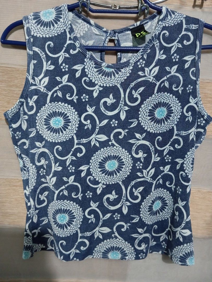 Per Seption Floral Sleeveless Top Blue (Category: Sleeveless) located in Taguig. Submitted by louiseaust63096 (Listing ID 1466648492, Image 1). Description: Blue sleeveless top by Per Seption featuring white and turquoise floral patterns, a round neckline with a back keyhole button, and lightweight fabric. Perfect for warm weather and easily paired with jeans or skirts..
