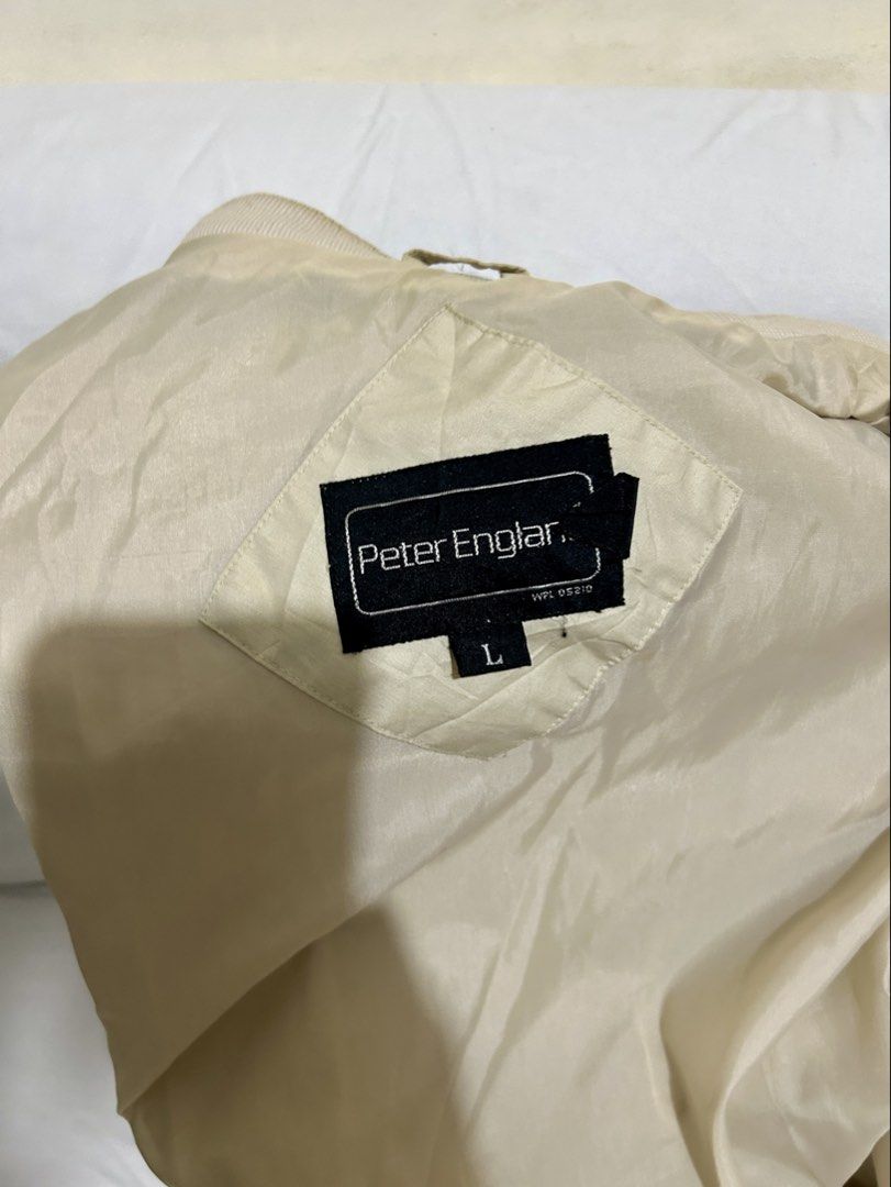 Peter England Beige Bomber Jacket Size L (Category: Coats, Jackets and Outerwear) located in Manila. Submitted by mihos.garage.sale (Listing ID 1466604666, Image 3). Description: - Brand: Peter England - Size: Large - Color: Neutral beige / cream - Closure: Full zip front - Pockets: Convenient side slit pockets - Details: Shoulder epaulets, ribbed cuffs and hem - Style: Classic casual outerwear, perfect for everyday wear.