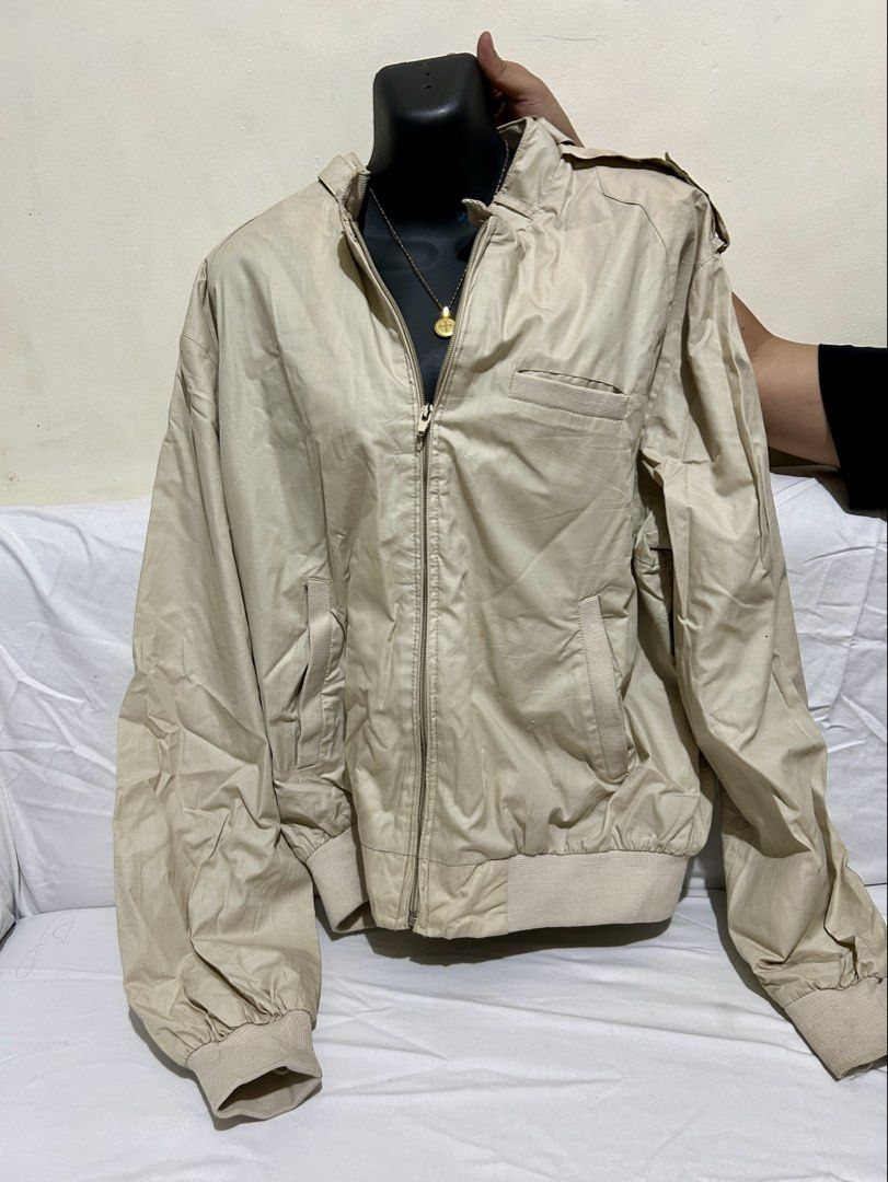 Peter England Beige Bomber Jacket Size L (Category: Coats, Jackets and Outerwear) located in Manila. Submitted by mihos.garage.sale (Listing ID 1466604666, Image 1). Description: - Brand: Peter England - Size: Large - Color: Neutral beige / cream - Closure: Full zip front - Pockets: Convenient side slit pockets - Details: Shoulder epaulets, ribbed cuffs and hem - Style: Classic casual outerwear, perfect for everyday wear.