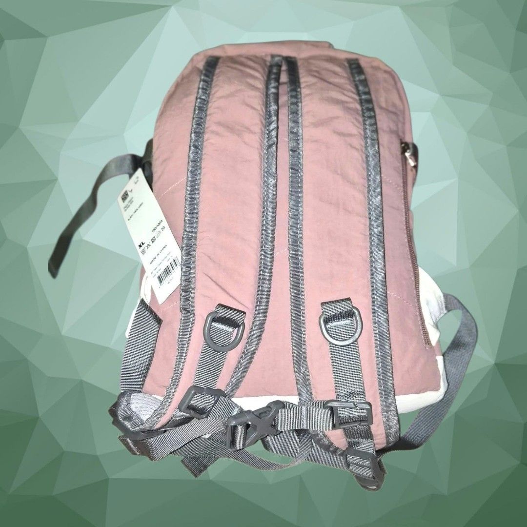 Pink and White Casual Backpack with Bungee Cords (Category: Backpacks) located in Paranaque City. Submitted by calm_youngstore7 (Listing ID 1466724013, Image 2). Description: - Color: Pink and white with grey straps - Size: XL (brand new with original tag attached) - Storage: Main zippered compartment, side zipper pockets, and side slip pockets - Features: Adjustable bungee cord lacing system on the front, padded shoulder straps, and top grab han