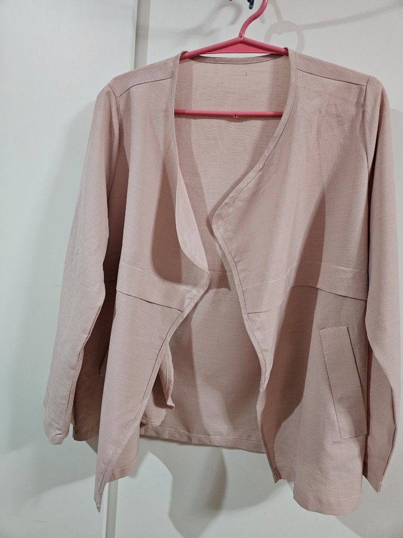 Pink Open Front Blazer Jacket with Pockets (Category: Coats, Jackets and Outerwear) located in Caloocan City. Submitted by rm.diaz (Listing ID 1466609436, Image 1). Description: - Color: Dusty pink - Style: Open front lightweight blazer - Details: Lapel collar, two front pockets, clean back seam - Sleeves: Long sleeves with adjustable button tab details - Versatility: Easy to match and great for layering over tops or dresses.