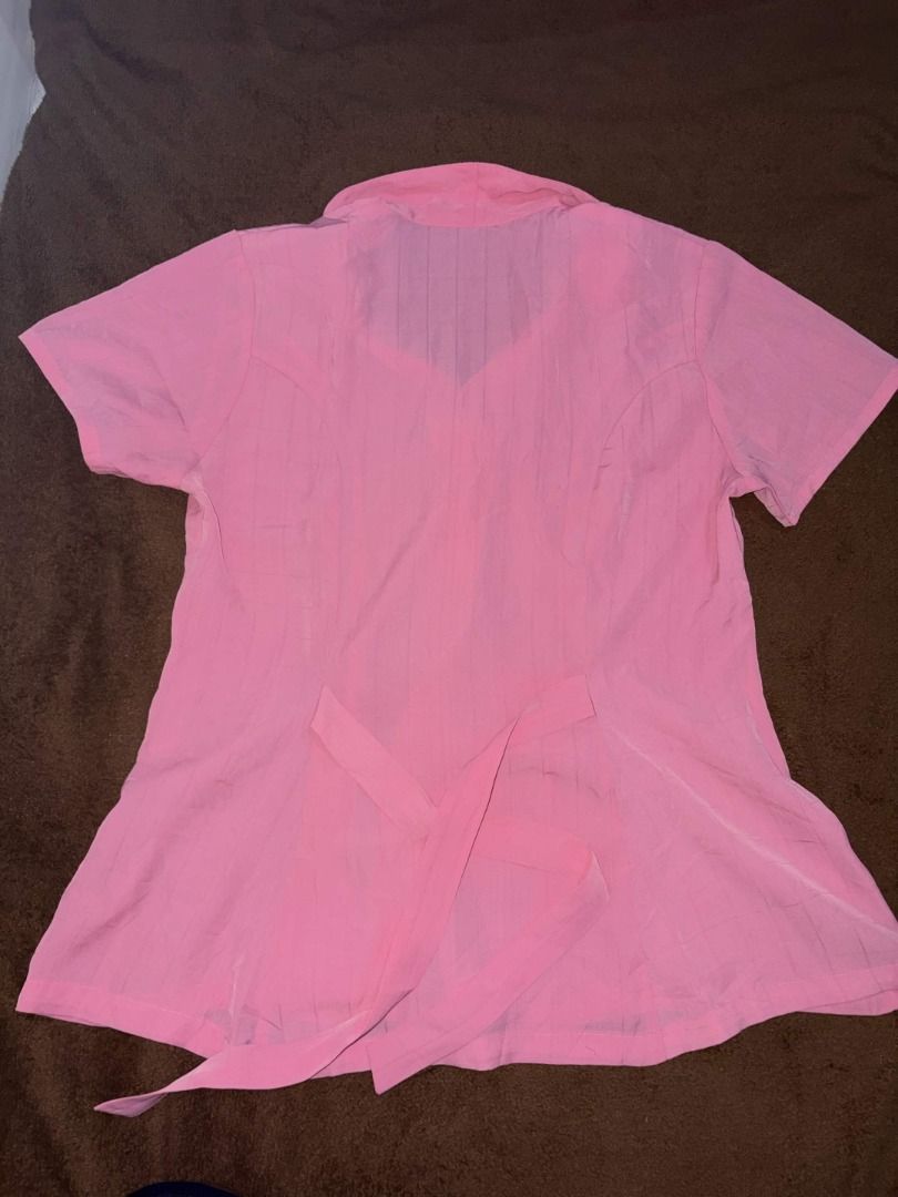 Pink Short Sleeve Collared Blouse | Tie-Back Office Top (Category: Blouses) located in Quezon City. Submitted by gonzotrickster9899 (Listing ID 1466661171, Image 3). Description: Selling this versatile pink button-down top, perfect for office wear or everyday casual outfits. - Features a neat collar, front buttons, and waist ties at the back to easily adjust the silhouette. - The color is a vibrant solid pink. - Gently used, no noticeable flaws o