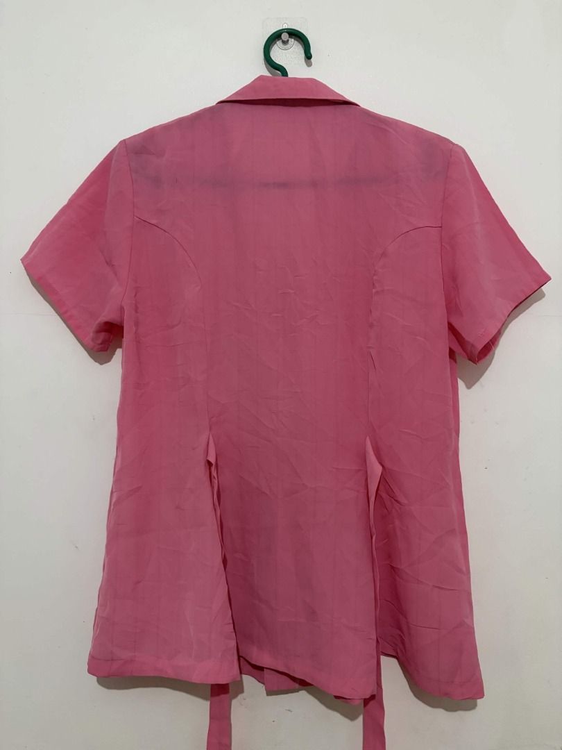 Pink Short Sleeve Collared Blouse | Tie-Back Office Top (Category: Blouses) located in Quezon City. Submitted by gonzotrickster9899 (Listing ID 1466661171, Image 2). Description: Selling this versatile pink button-down top, perfect for office wear or everyday casual outfits. - Features a neat collar, front buttons, and waist ties at the back to easily adjust the silhouette. - The color is a vibrant solid pink. - Gently used, no noticeable flaws o