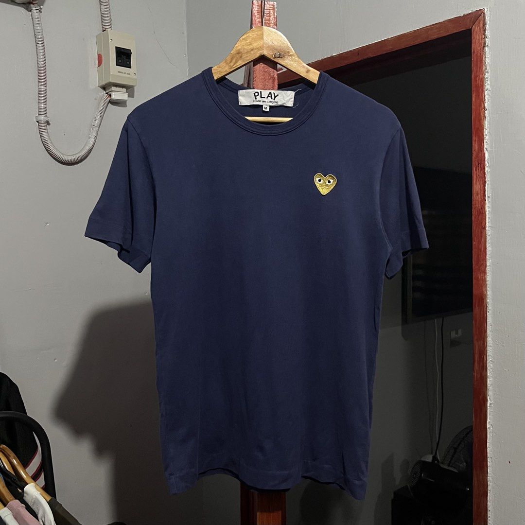 PLAY Comme Des Garcons Gold Emblem Tshirt (Category: Tshirts & Polo Shirts ) located in Davao. Submitted by lwndvo (Listing ID 1466603844, Image 3). Description: PLAY Comme Des Garcons Gold Emblem Tshirt Authentic Excellent UC Dimensions: Width: 18 Length: 26 Issue/s: Sign of use Price: 980 + shipping .