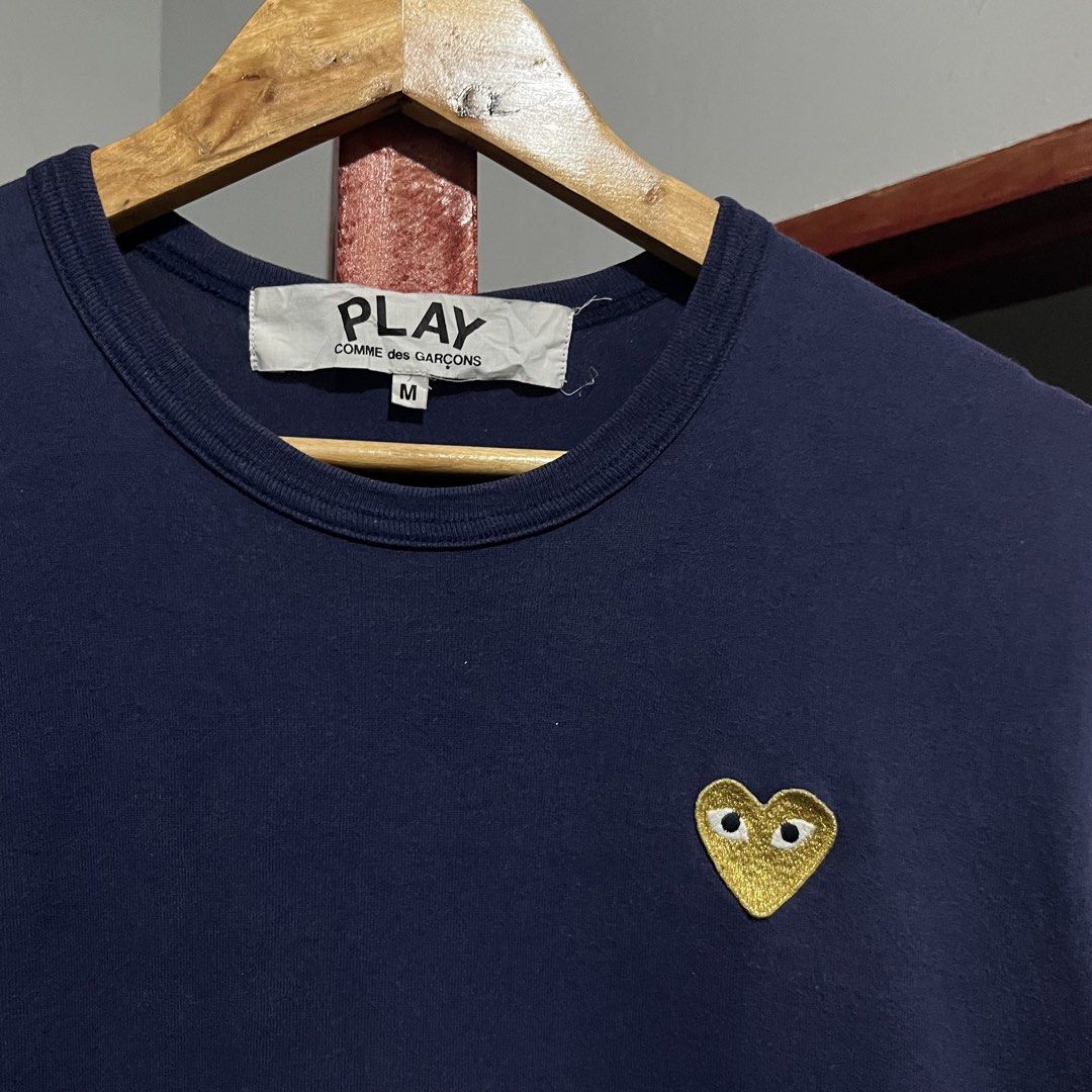 PLAY Comme Des Garcons Gold Emblem Tshirt (Category: Tshirts & Polo Shirts ) located in Davao. Submitted by lwndvo (Listing ID 1466603844, Image 1). Description: PLAY Comme Des Garcons Gold Emblem Tshirt Authentic Excellent UC Dimensions: Width: 18 Length: 26 Issue/s: Sign of use Price: 980 + shipping .