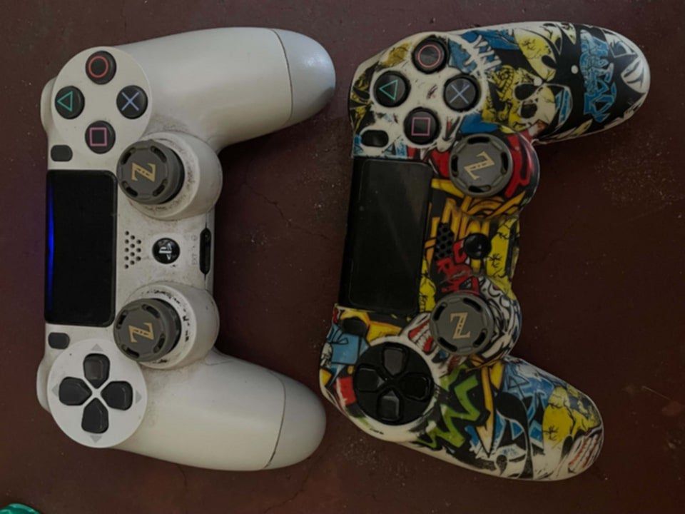 PlayStation 4 Console with 2 Controllers and Games (Category: PlayStation) located in Quezon City. Submitted by beauty_finds_right (Listing ID 1466705489, Image 2). Description: - PlayStation 4 console in fully working condition - Includes 2 controllers: 1 standard white and 1 with a custom graffiti skin - Comes with a connected external hard drive - Pre-installed digital games including Red Dead Redemption 2 and Resident Evil 4 - All necessary p