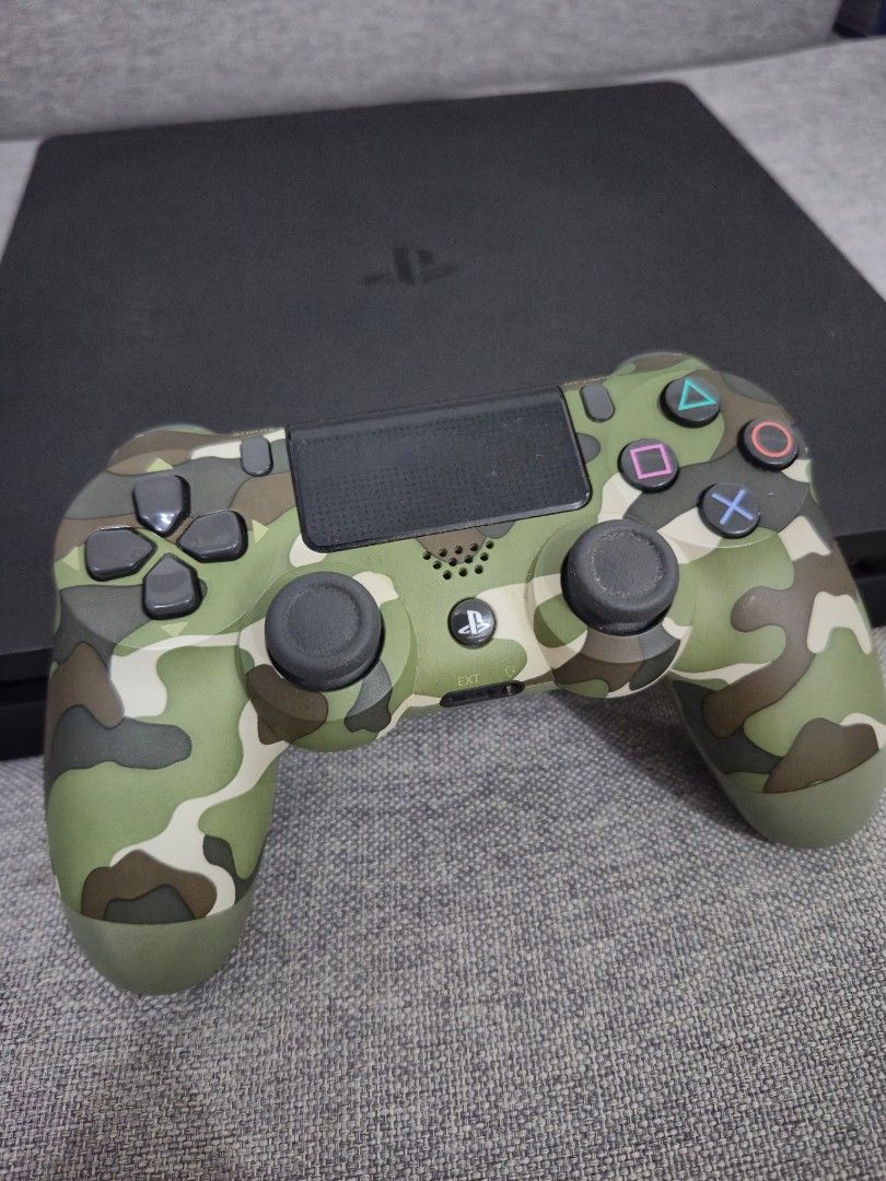 PlayStation 4 Slim Console with Controller and Dobe Charging Dock (Category: PlayStation) located in Manila. Submitted by iveepee (Listing ID 1466769158, Image 3). Description: - PlayStation 4 Slim black console (fully tested and 100% working) - 1x DualShock 4 wireless controller with green camo silicone case - 1x Dobe dual charging dock stand - Complete ready-to-play bundle for your gaming setup - Fast shipping and trusted seller.