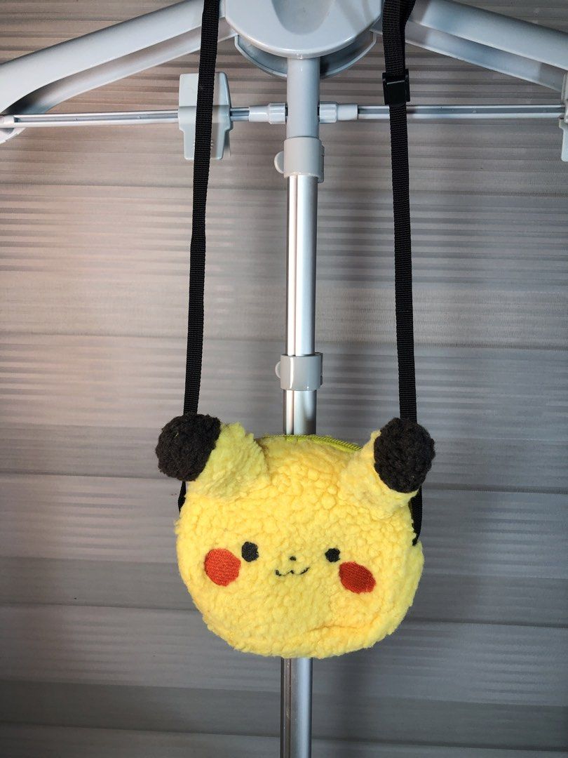 Pokémon Pikachu Plush Crossbody Bag (Category: Babies & Kids Fashion) located in Manila. Submitted by all.dressed.up (Listing ID 1466773634, Image 1). Description: Super soft & fluffy: Bright yellow sherpa fleece texture with adorable 3D plush ears Cute details: Embroidered red cheeks and stitched happy smile Secure & practical: Zip-top closure with clean yellow lining Adjustable fit: Comes with a sturdy, adjustable black nylon strap Perfect dail