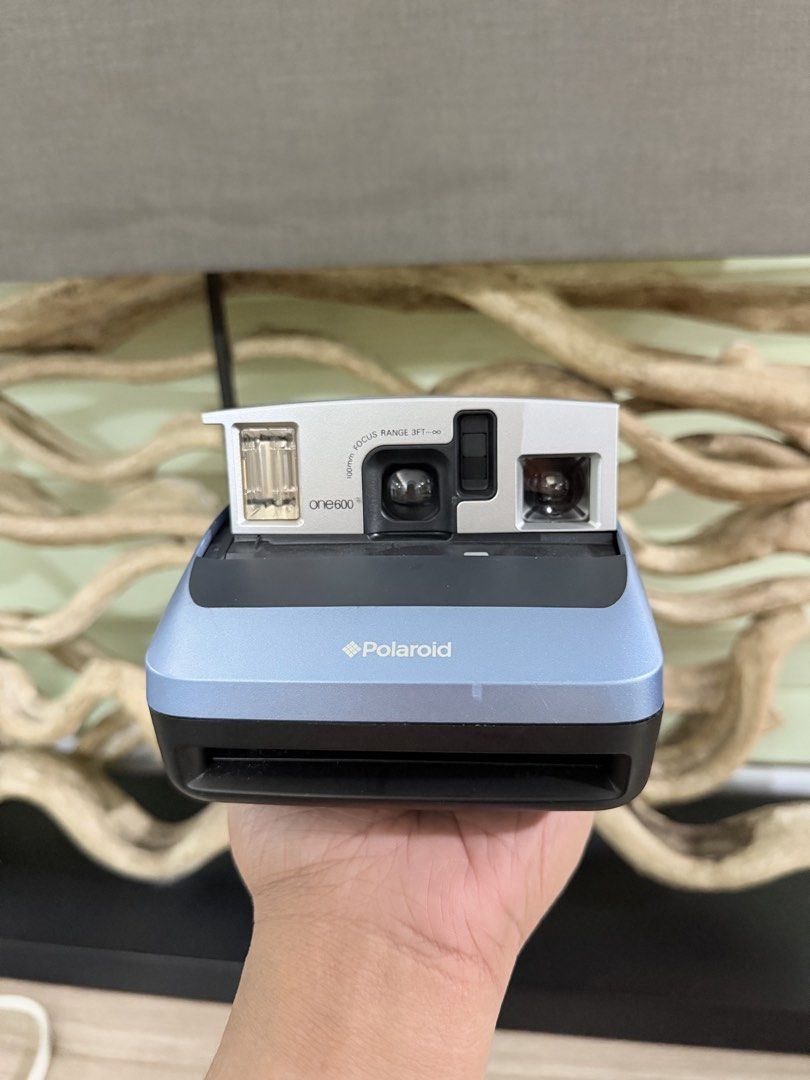 Polaroid one600 Instant Film Camera (Category: Cameras) located in Pasig City. Submitted by iambernabe (Listing ID 1466713003, Image 2). Description: - Model: Polaroid one600 Instant Film Camera - Color: Blue and silver colorway - Lens: 100mm focus lens (ranges from 3 feet to infinity) - Flash: Built-in flash for low-light shooting - Film Type: Uses standard 600 type film - Extras: Original strap attached to the side - Condition: Clean body with 