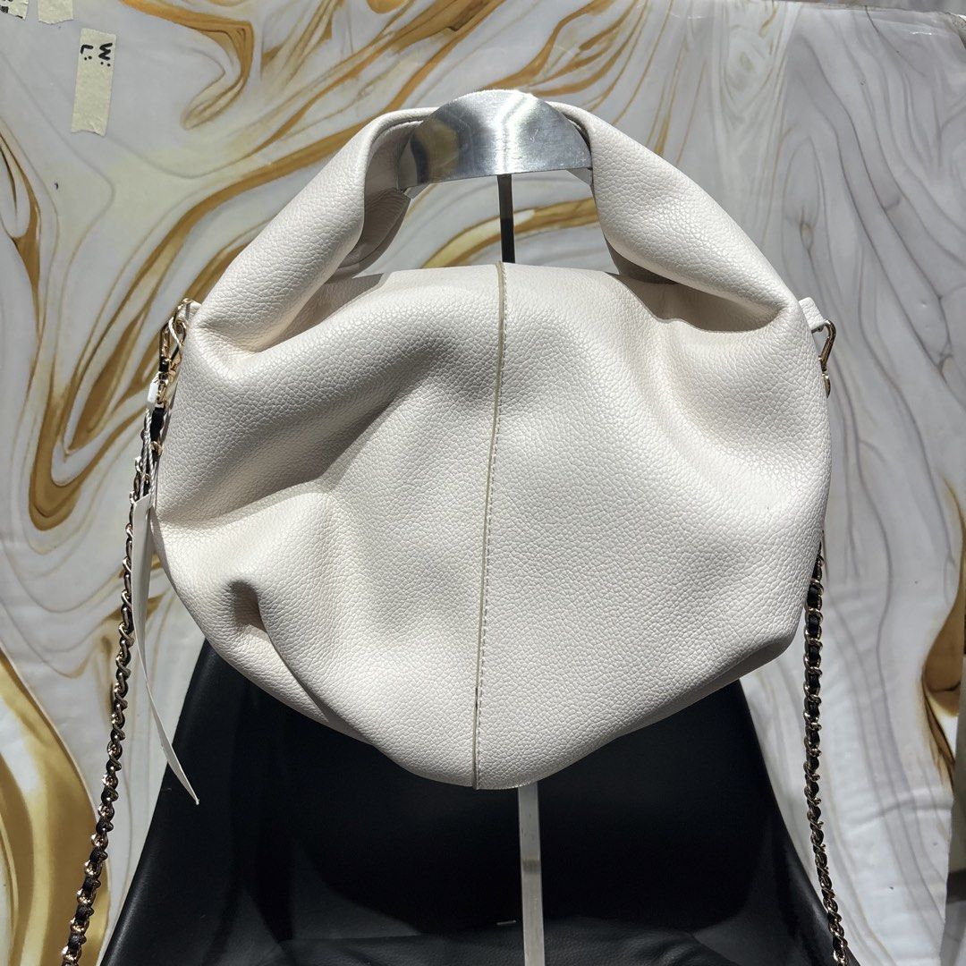 Polène White Leather Handbag with sling (Category: Luxury Bags & Wallets) located in Bambang. Submitted by heats777 (Listing ID 1466662910, Image 1). Description: - Brand: Polène - Color/Material: Textured white full-grain Italian calfskin - Hardware: Gold-tone - Interior: Velvet microfiber lining with brand label and serial number 11554 - Strap/Handles: Chain strap and gathered top handles - Origin: Made in Spain - Condition: Tag attached, spaci