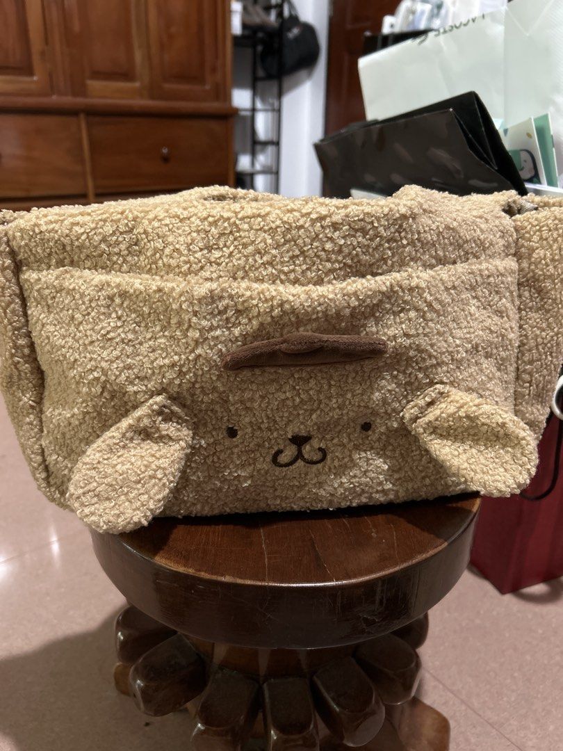 Pompompurin Fluffy Sherpa Tote Bag (Category: Tote Bags) located in Alitagtag. Submitted by patrickvillanueva (Listing ID 1466629952, Image 1). Description: I bought this from Japan Fuzzy Pompompurin tote bag in beige sherpa material. Brown embroidered face details with floppy ears on the front, plus a label patch on the back. Smooth lining inside with open main compartment and sturdy handles. Soft textured fabric all over..