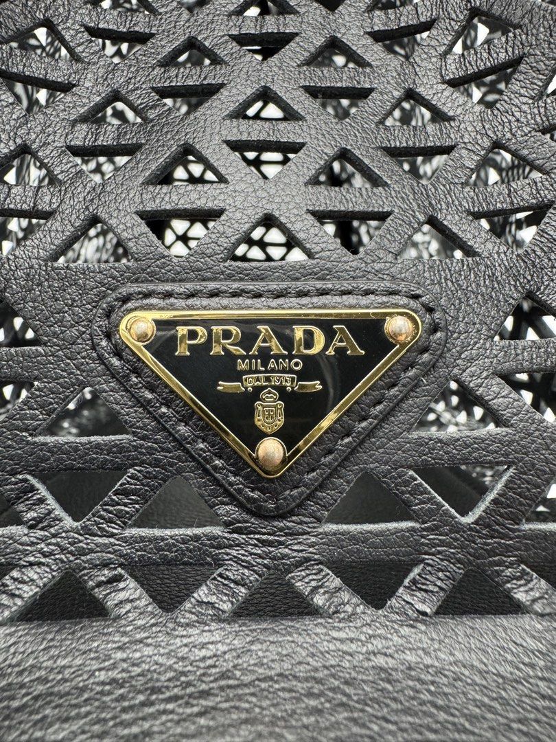Prad@ Black Cutout Leather Tote Handbag (Category: Tote Bags) located in Calauan. Submitted by giftbags (Listing ID 1466763519, Image 3). Description: ❗️PLEASE READ CAREFULLY ❗️ Prada Cut Out Logo Tote in Black Size: L11.75 x H9 x W6.25 in Drop: 4 in With Dust bag STILL AVAILABLE/ONHAND? Yes. Item not marked as sold means available… 📌NO COD 📌NO LALAMOVE/GRAB 📌NO WHEN WORN 📌ITEMS ARE FOR SHIPPING ONLY - CUT OFF 12nn 📌ALL SALES ARE FINAL “WHAT