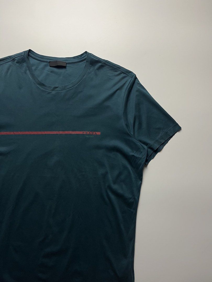 Prada Linea Rossa Tshirt (Category: Luxury Apparel) located in Manila. Submitted by streetsavvy (Listing ID 1466650826, Image 3). Description: Prada Linea Rossa Tshirt Size: XL Width: 22.5” Length: 30” Shoulder: 18.5” Sleeve Length: 8.5” Hem: 21.5” Measured in Inches Condition: Good condition with signs of wear Flaw: 1 Pinhole.