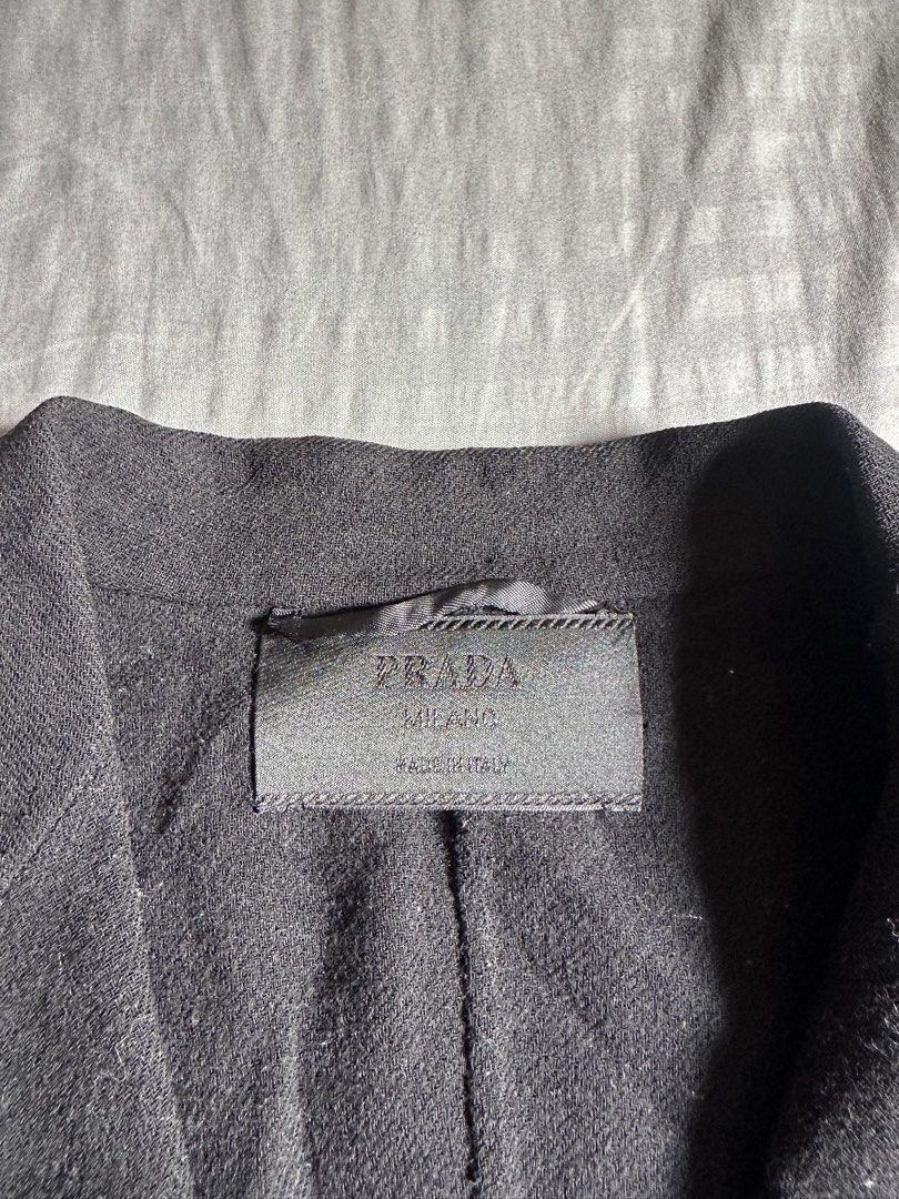 Prada Milano Black Wool Blazer Size 38 (Category: Coats, Jackets and Outerwear) located in Quezon City. Submitted by stre3tw3ar (Listing ID 1466624658, Image 2). Description: - Brand: Prada Milano - Color: Black - Size: 38 (Label) - Material: Premium wool blend - Origin: Made in Italy - Fit: Tailored, structured silhouette - Details: Single-breasted button closure, flap pockets, and button cuffs - Condition: Excellent - Perfect for formal events,