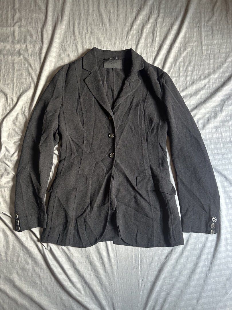 Prada Milano Black Wool Blazer Size 38 (Category: Coats, Jackets and Outerwear) located in Quezon City. Submitted by stre3tw3ar (Listing ID 1466624658, Image 1). Description: - Brand: Prada Milano - Color: Black - Size: 38 (Label) - Material: Premium wool blend - Origin: Made in Italy - Fit: Tailored, structured silhouette - Details: Single-breasted button closure, flap pockets, and button cuffs - Condition: Excellent - Perfect for formal events,