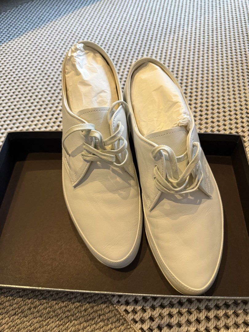 Prada White Leather Derby Sneakers (Category: Casual Shoes) located in Manila. Submitted by shan.rubio (Listing ID 1466643486, Image 3). Description: - Authentic Prada white leather derby sneakers - Features a stylish contrasting black stripe on the midsole - Smooth leather upper with traditional lace-up closure - Clean stitching and structured heel panels for durability - Size tag clearly readable near the collar - Includes original branded shoe