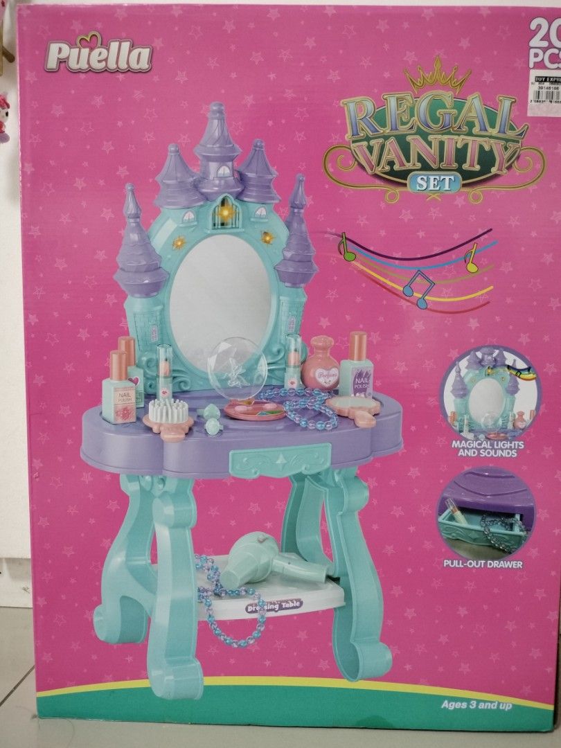 Puella Regal Vanity Set Toy Dressing Table (Category: Kids Toys) located in San Mateo. Submitted by shop_with_nicer (Listing ID 1466617020, Image 2). Description: - Magical castle-themed vanity set in fun pink, blue, and purple colors - Complete 20-piece set including a working toy hair dryer, pretend perfume, makeup, and jewelry - Features an interactive mirror with lights and sounds - Includes a convenient pull-out drawer for accessory storage 