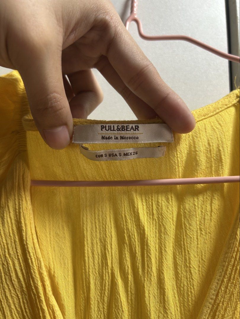 Pull&Bear Yellow Button-Front Midi Dress Size S (Category: Dresses) located in Quezon City. Submitted by emayeah (Listing ID 1466574635, Image 2). Description: - Brand: Pull&Bear - Size: EUR S, USA S, MEX 26 - Color: Bright yellow - Style: Sleeveless midi dress with V-neckline, front button placket, textured fabric, and high-low hem - Condition: Good, with a small snag/hole repair visible on the upper right bust area - Perfect casual piece for su