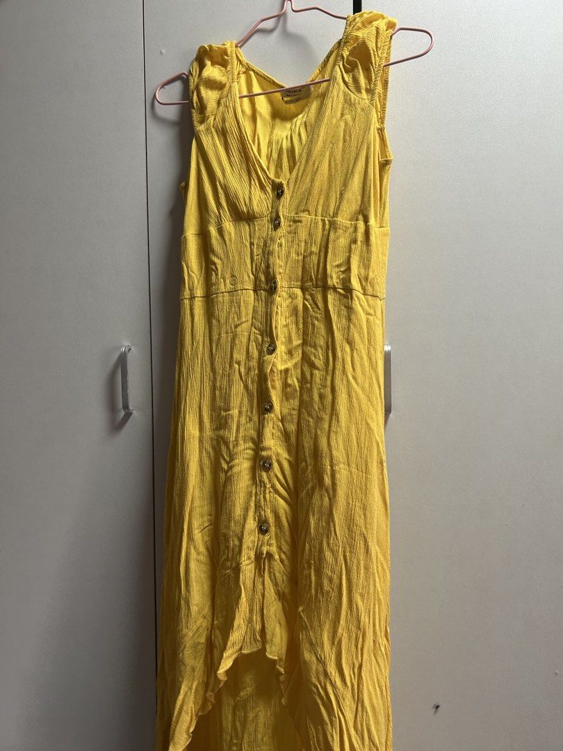 Pull&Bear Yellow Button-Front Midi Dress Size S (Category: Dresses) located in Quezon City. Submitted by emayeah (Listing ID 1466574635, Image 3). Description: - Brand: Pull&Bear - Size: EUR S, USA S, MEX 26 - Color: Bright yellow - Style: Sleeveless midi dress with V-neckline, front button placket, textured fabric, and high-low hem - Condition: Good, with a small snag/hole repair visible on the upper right bust area - Perfect casual piece for su