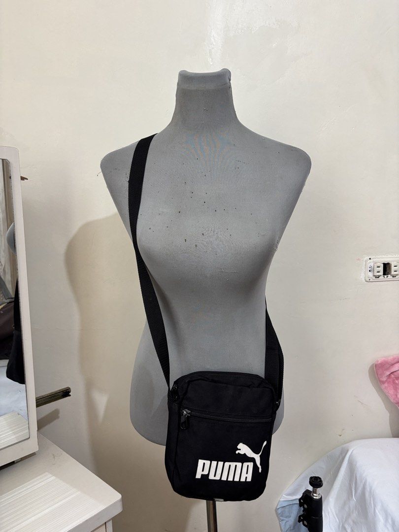 Puma Black Crossbody Bag (Category: Sling Bags) located in Bacolod City. Submitted by 2399kayara18627 (Listing ID 1466602769, Image 2). Description: - Brand: Puma - Color: Classic black with white logo - Storage: Main zip compartment + extra front zip pocket - Strap: Adjustable shoulder strap - Capacity: Easily fits phone, wallet, and keys - Best for: Daily use, running errands, or traveling light - Condition: Brand new / Excellent.