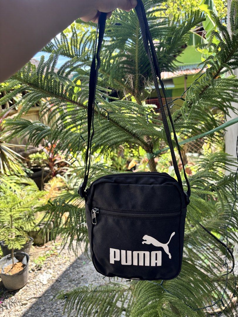 Puma Black Crossbody Bag (Category: Sling Bags) located in Bacolod City. Submitted by 2399kayara18627 (Listing ID 1466602769, Image 1). Description: - Brand: Puma - Color: Classic black with white logo - Storage: Main zip compartment + extra front zip pocket - Strap: Adjustable shoulder strap - Capacity: Easily fits phone, wallet, and keys - Best for: Daily use, running errands, or traveling light - Condition: Brand new / Excellent.