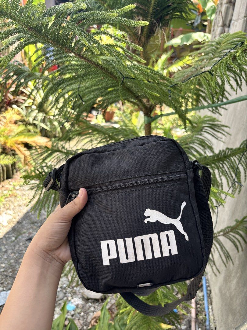 Puma Black Crossbody Bag (Category: Sling Bags) located in Bacolod City. Submitted by 2399kayara18627 (Listing ID 1466602769, Image 3). Description: - Brand: Puma - Color: Classic black with white logo - Storage: Main zip compartment + extra front zip pocket - Strap: Adjustable shoulder strap - Capacity: Easily fits phone, wallet, and keys - Best for: Daily use, running errands, or traveling light - Condition: Brand new / Excellent.