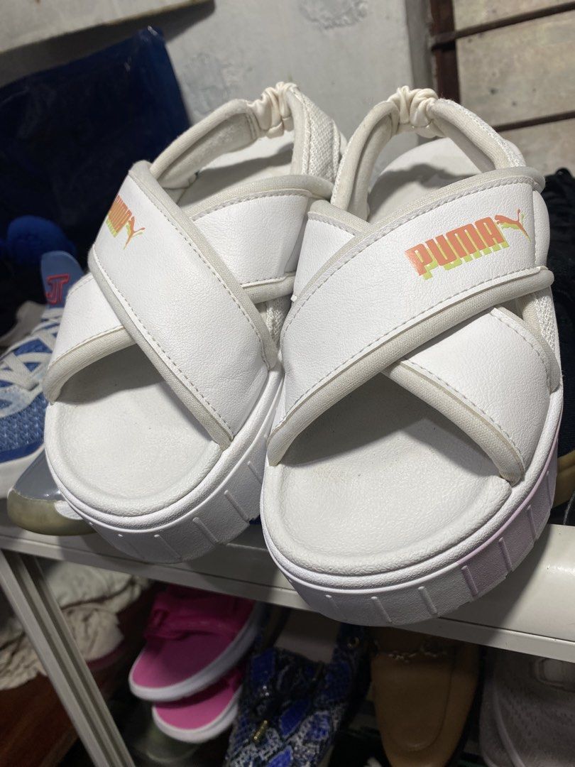 Puma Mayandal White Cross Strap Platform Sandals (Category: Flats & Sandals) located in Baguio. Submitted by workwear2600 (Listing ID 1466591407, Image 3). Description: - Brand: Puma - Style: Platform sandals with chunky crossover straps - Colorway: White with bright orange and yellow side branding - Details: Pastel pink and green block midsole, adjustable heel strap - Comfort: Super comfy cushioned sole and wearable platform height - Versatility