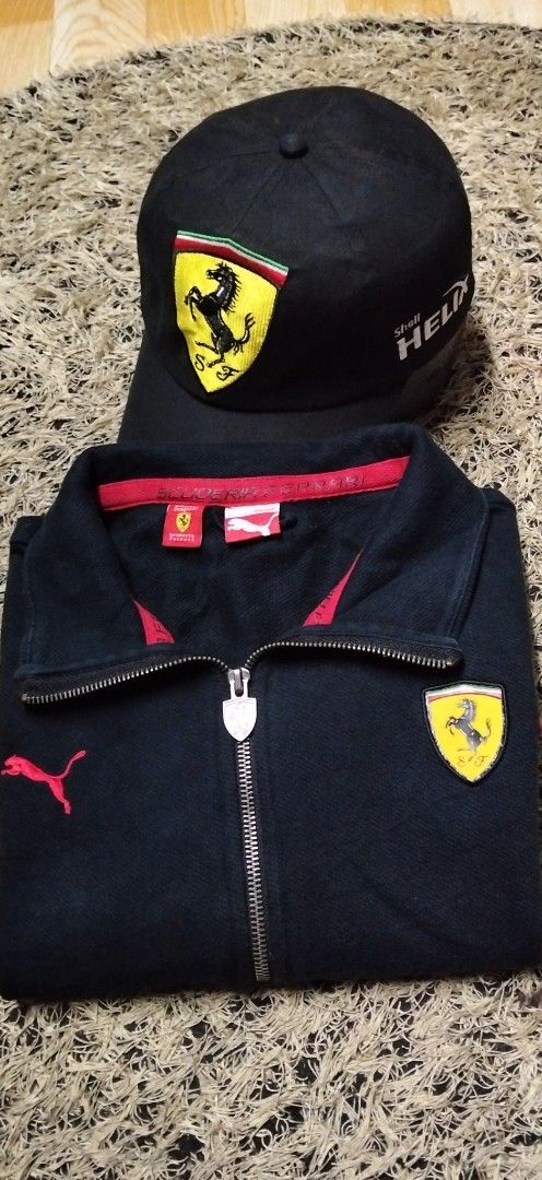 Puma Scuderia Ferrari Zip Jacket and Cap (Category: Coats, Jackets and Outerwear) located in Paranaque City. Submitted by michael-08 (Listing ID 1466755663, Image 1). Description: - Authentic Puma Scuderia Ferrari bundle: Jacket and matching cap - Color: Sleek black with bold red piping details - Jacket Size: Large (L) - Branding: Official Ferrari tags, branded zipper pulls, and embroidered shield patches on both chest and cap - Bonus: Shell Heli