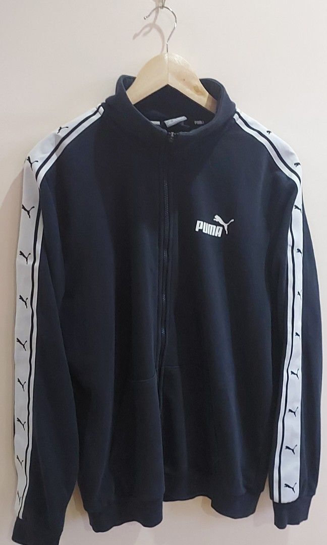 PUMA T7 Track Jacket (Category: Activewear) located in Pozorrubio. Submitted by infinite_grind_0.1 (Listing ID 1466669260, Image 1). Description: 450 This is a classic black PUMA T7 Track Jacket featuring distinct white logo taping along both sleeves. on tape: chest 23 length 26.