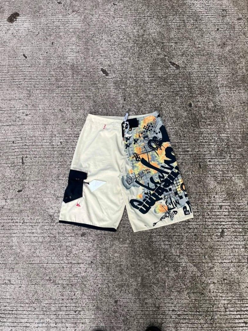 Quiksilver Board Shorts Surf Swim Trunks (Category: Swim Trunks & Board Shorts) located in Sipalay. Submitted by yon.thrifter (Listing ID 1466773281, Image 1). Description: - Brand: Quiksilver - Dimension: W34 L22 - Design: Unique split design (cream side + bold black, yellow, and grey graphic side) - Features: Drawstring waist with contrast eyelets and eye-catching leg graphics - Storage: Convenient side cargo pocket with an included surf wax co
