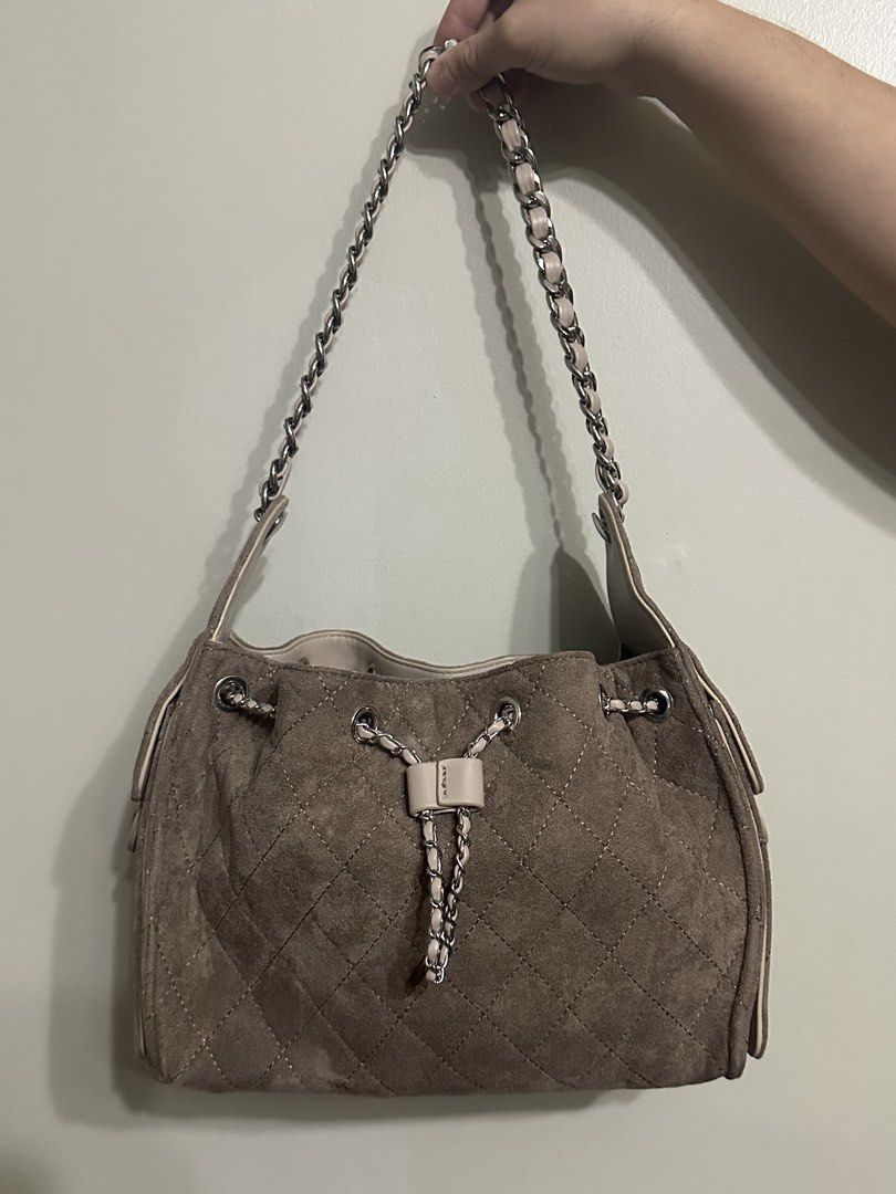Quilted suede shoulder bag with chain strap (Category: Shoulder Bags) located in Bulacan. Submitted by savifinds (Listing ID 1466601464, Image 1). Description: Taupe suede shoulder bag with diamond quilting. Silver chain straps interwoven with leather strips. Drawstring closure featuring metal chains and a center leather tab. Soft slouchy shape. Clean lining inside..