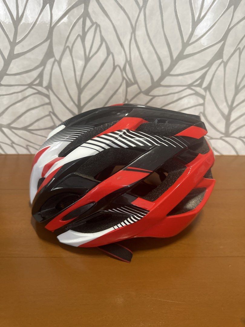 Red Black and White Cycling Helmet (Category: Bicycles) located in Makati City. Submitted by twodoxies (Listing ID 1466609449, Image 1). Description: - Color: Red, black, and white - Adjustable straps with quick-release buckle - Comfortable padded interior with mesh netting for airflow - Lightweight shell with multiple ventilation ports Location: Makati / Las Pinas.