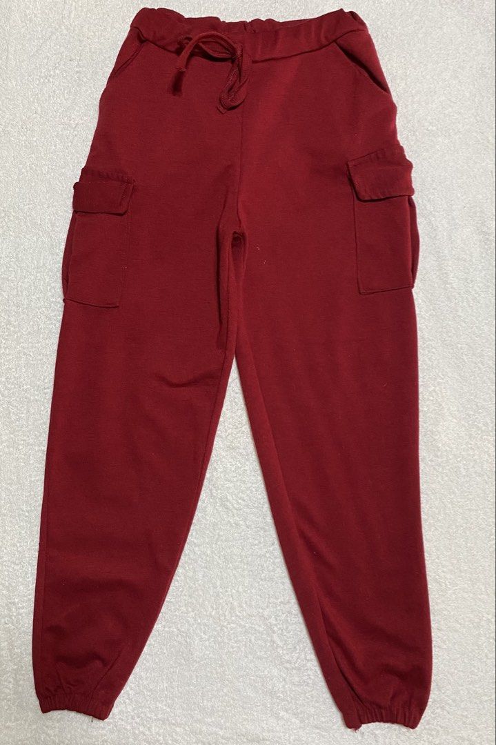 Red Cargo Joggers Sweatpants with Drawstring and Pockets (Category: Babies & Kids Fashion) located in Morong. Submitted by ladygjimenez0224 (Listing ID 1466654996, Image 1). Description: - Color: Deep red - Material: Soft and cozy cotton fleece - Waist: Elastic waistband with matching adjustable drawstring - Pockets: Two side utility cargo pockets with flaps plus regular slant pockets - Cuffs: Elastic ankle cuffs for a secure fit - Fit: Relaxed f
