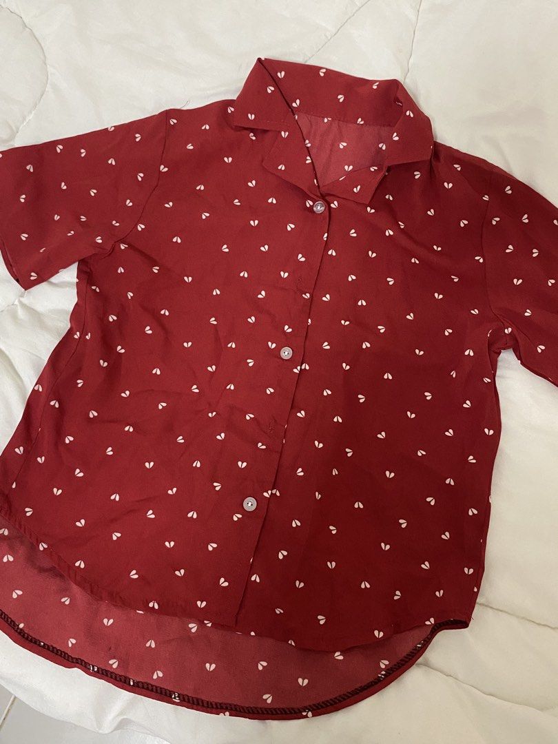 Red heart print short sleeve button down blouse (Category: Blouses) located in Manila. Submitted by eileenmaye67636 (Listing ID 1466694529, Image 1). Description: PRELOVED! need wash - Color & Pattern: Vibrant red with all-over small white hearts - Fit & Style: Short sleeve button-down with a classic collar and high-low curved hem - Material: Lightweight, breezy, and comfortable fabric shipping: j&t and lalamove .