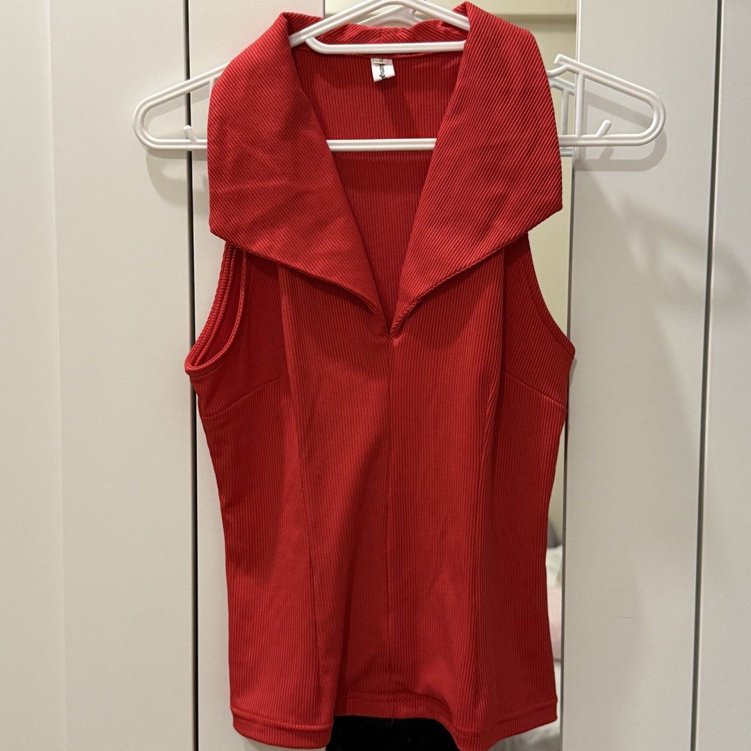 Red Ribbed Halter Top with Collar (Category: Sleeveless) located in Marikina City. Submitted by lovegoeson (Listing ID 1466687674, Image 1). Description: - Color: Bright red - Material: Stretchy ribbed knit fabric - Design: Big front collar with a deep V-neckline and clean halter back - Fit: Slim fit silhouette - Condition: Worn just once for photos, practically brand new - Styling tip: Pairs perfectly with black pants or jeans.