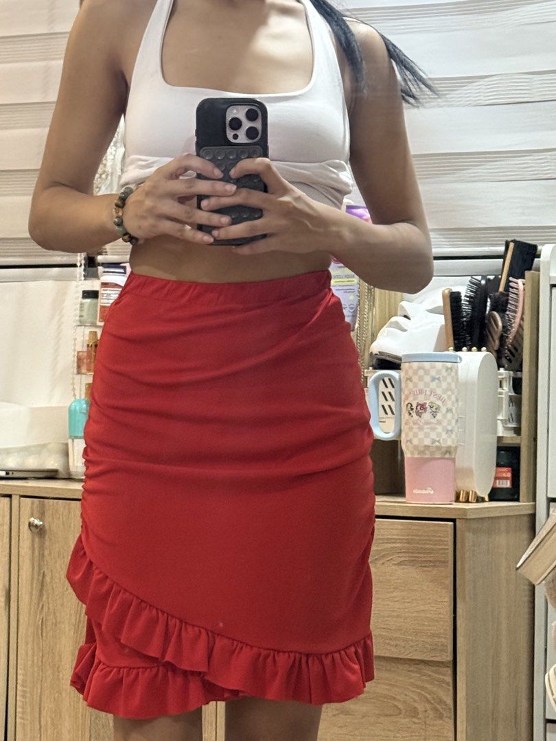 Red ruffled mini skirt elastic waist (Category: Skirts) located in Manila. Submitted by mightystone-d948cd (Listing ID 1466771860, Image 3). Description: - Color: Vibrant red - Style: Mini skirt with a diagonal layered ruffle hem - Waistband: Elastic for an easy, comfortable fit - Fabric: Smooth and lightweight - Occasion: Great for casual daytime wear or nights out - Note: Measurements and fit details available upon request.