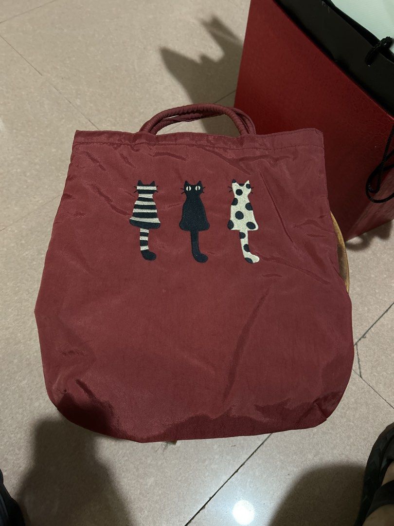 Red Tote Bag with Three Cats Embroidery (Category: Tote Bags) located in Alitagtag. Submitted by patrickvillanueva (Listing ID 1466629185, Image 1). Description: - Material: Durable, high-quality fabric - Design: Features 3 embroidered cats (striped, solid black, and polka dot) - Features: Sturdy dual top handles for easy carrying - Size: Compact yet spacious enough for daily essentials - Style: Casual everyday bag, perfect gift for cat lovers!.