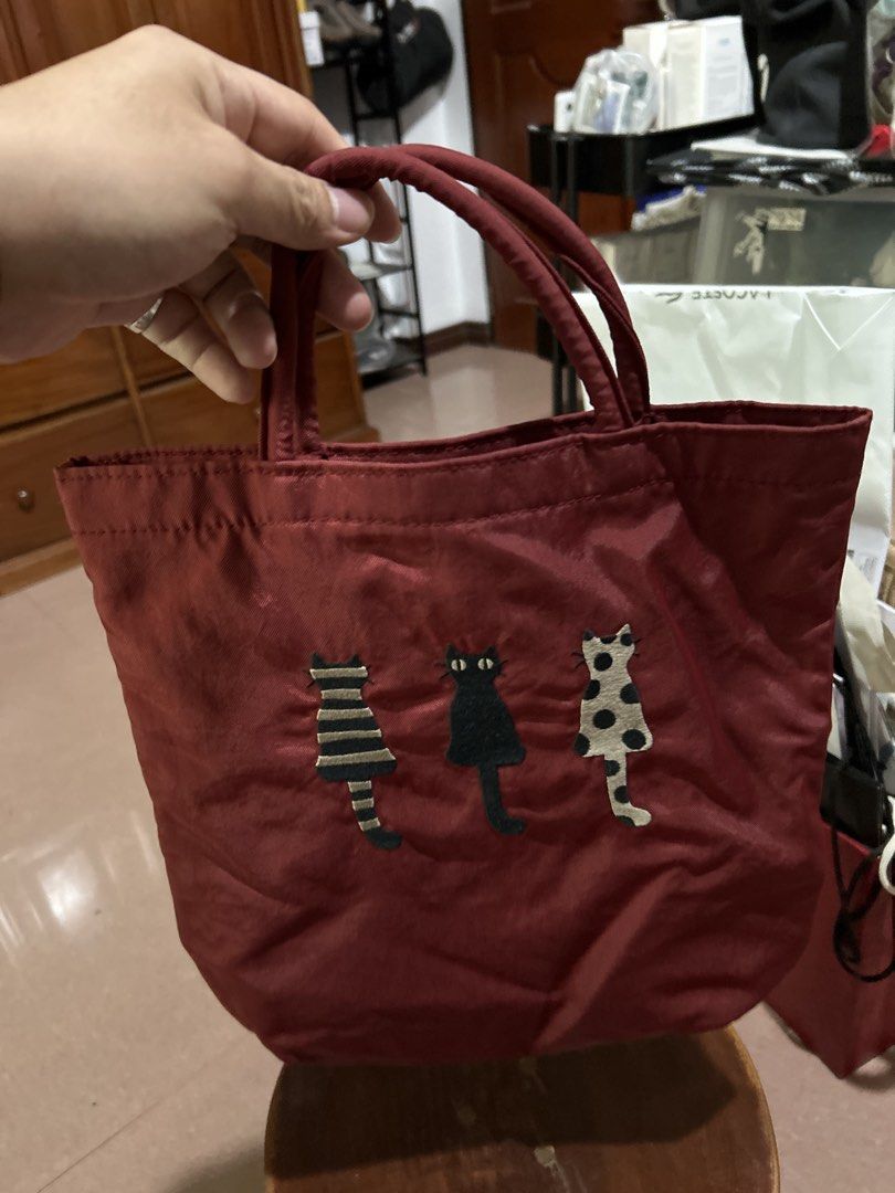 Red Tote Bag with Three Cats Embroidery (Category: Tote Bags) located in Alitagtag. Submitted by patrickvillanueva (Listing ID 1466629185, Image 3). Description: - Material: Durable, high-quality fabric - Design: Features 3 embroidered cats (striped, solid black, and polka dot) - Features: Sturdy dual top handles for easy carrying - Size: Compact yet spacious enough for daily essentials - Style: Casual everyday bag, perfect gift for cat lovers!.
