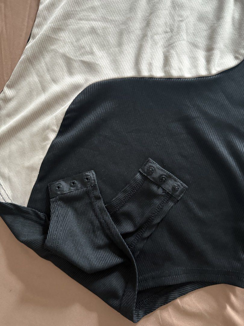 Ribbed Bodysuit Size M (Category: Sleeveless) located in Pasay City. Submitted by cheyennesayson (Listing ID 1466573967, Image 2). Description: - Brand: SHEIN - Size: M - Style: Sleeveless round neck bodysuit with snap closure - Design: Wavy colorblock front (black & beige) with solid black back - Material: Stretchy, super comfortable ribbed fabric - Condition: Brand new / Excellent.