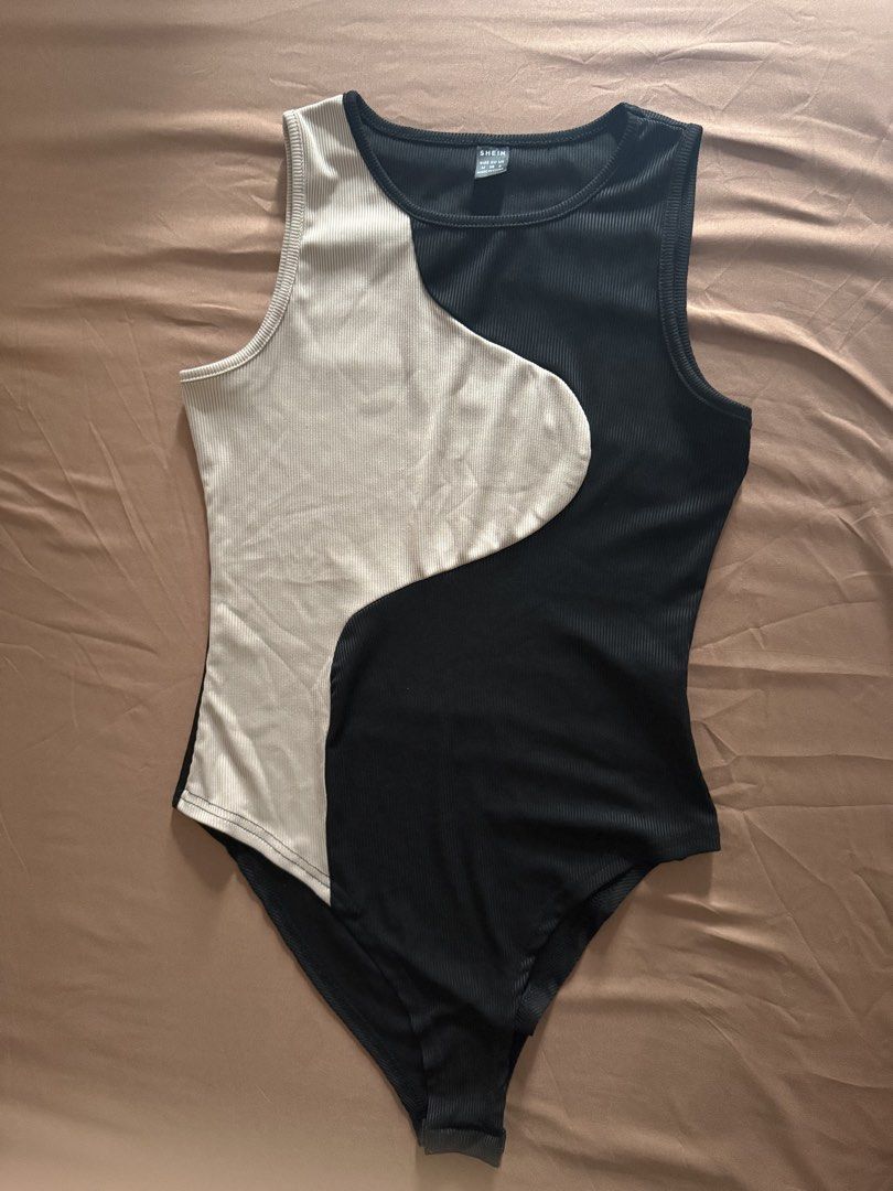 Ribbed Bodysuit Size M (Category: Sleeveless) located in Pasay City. Submitted by cheyennesayson (Listing ID 1466573967, Image 1). Description: - Brand: SHEIN - Size: M - Style: Sleeveless round neck bodysuit with snap closure - Design: Wavy colorblock front (black & beige) with solid black back - Material: Stretchy, super comfortable ribbed fabric - Condition: Brand new / Excellent.