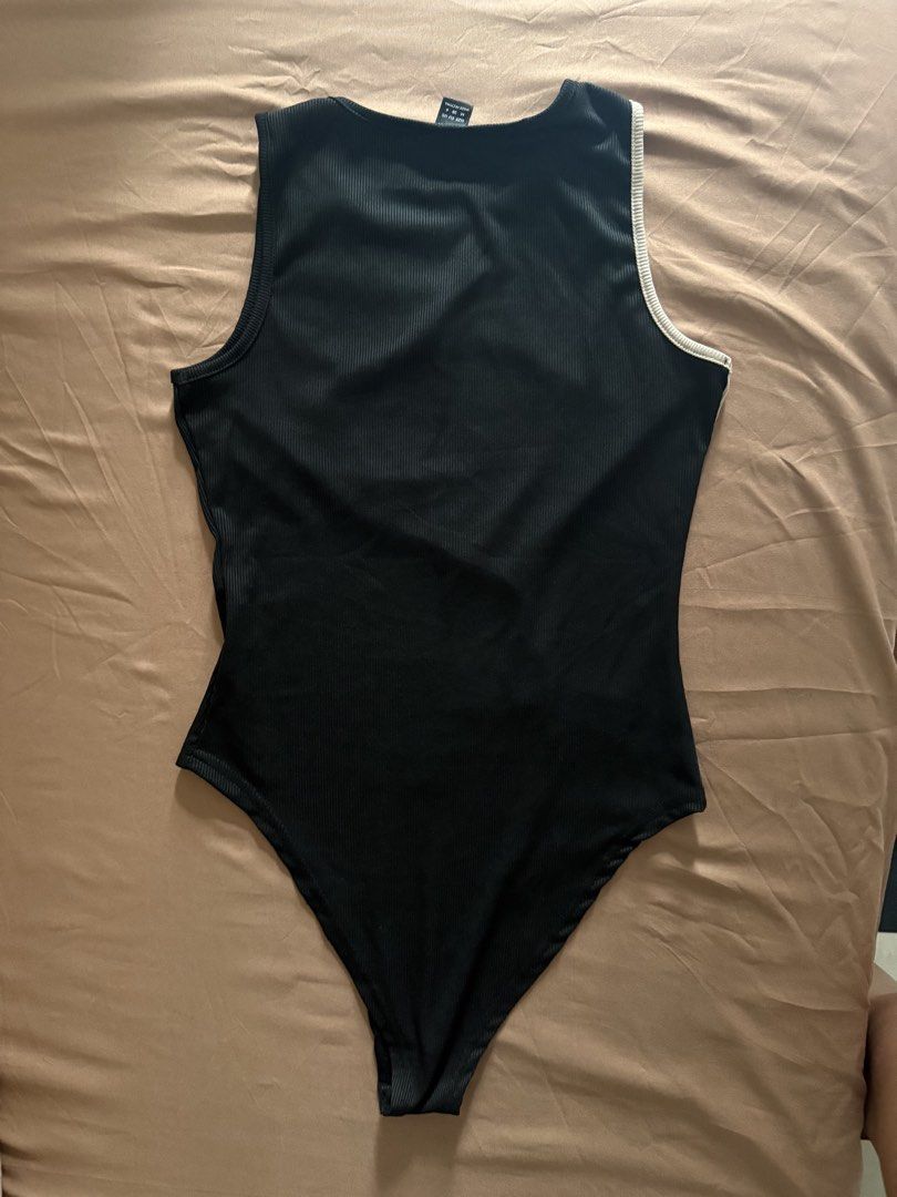 Ribbed Bodysuit Size M (Category: Sleeveless) located in Pasay City. Submitted by cheyennesayson (Listing ID 1466573967, Image 3). Description: - Brand: SHEIN - Size: M - Style: Sleeveless round neck bodysuit with snap closure - Design: Wavy colorblock front (black & beige) with solid black back - Material: Stretchy, super comfortable ribbed fabric - Condition: Brand new / Excellent.