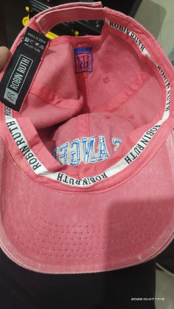 Robin Ruth Los Angeles Pink Baseball Cap (Category: Caps & Hats) located in Manila. Submitted by rhobin.m08 (Listing ID 1466704903, Image 3). Description: - Brand: Robin Ruth - Color: Pink with bold blue 'Los Angeles' and 'Original 1848' embroidery on front and back - Material: 100% breathable cotton - Fit: Adjustable strap in the back for a custom fit - Details: Features branded interior taping - Condition: Excellent, perfect for everyday casual