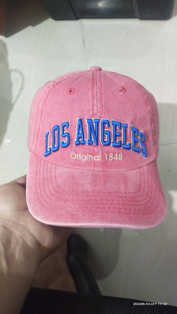 Robin Ruth Los Angeles Pink Baseball Cap (Category: Caps & Hats) located in Manila. Submitted by rhobin.m08 (Listing ID 1466704903, Image 1). Description: - Brand: Robin Ruth - Color: Pink with bold blue 'Los Angeles' and 'Original 1848' embroidery on front and back - Material: 100% breathable cotton - Fit: Adjustable strap in the back for a custom fit - Details: Features branded interior taping - Condition: Excellent, perfect for everyday casual