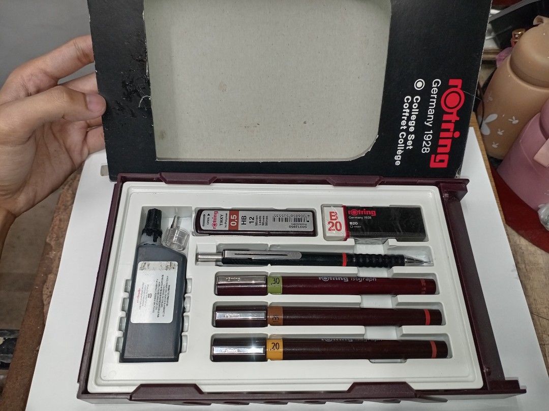 Rotring College Set Germany 1928 Technical Pen Set (Category: Stationery & School Supplies) located in Manila. Submitted by joelssalum87443 (Listing ID 1466692760, Image 3). Description: - Complete Rotring college drawing set in original maroon hardcase box - 3 Isograph technical pens: 0.20, 0.30, and 0.50 line widths - Rotring Tikky II 0.5mm mechanical pencil with replacement leads - Includes drawing ink bottle, B20 eraser, and compass attachmen