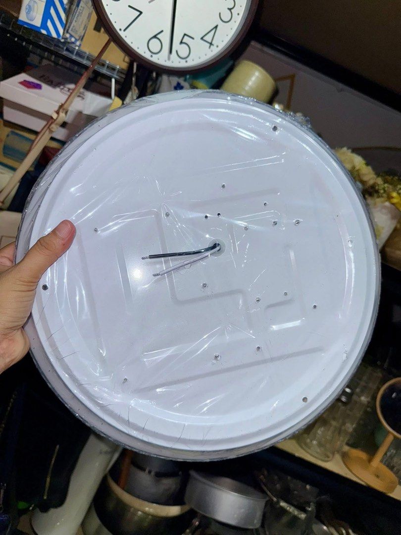 Round LED Ceiling Light White Fixture (Category: Lighting) located in Pilar. Submitted by faveanyshop (Listing ID 1466578646, Image 3). Description: - Type: Round white flush mount ceiling light fixture - Design: Decorative edge pattern with a subtle starry dot cover - Condition: Brand new, still wrapped in original protective plastic - Installation: Metal backing plate with pre-drilled holes and exposed wires for easy hardwiring - Finish: Clean 